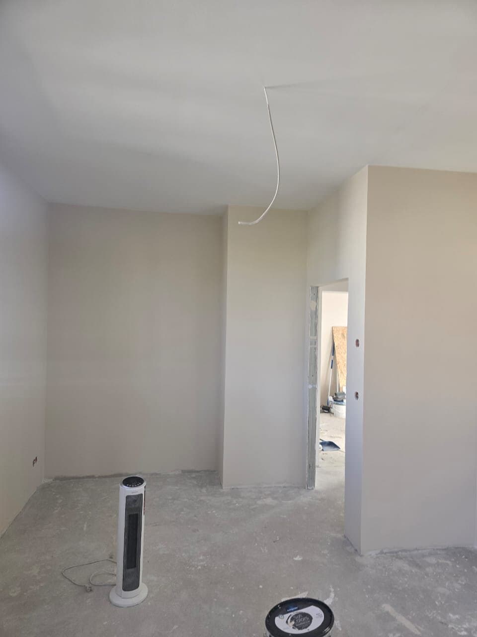 Malerarbeiten in einer Altbauwohnung: gespachtelte und geschliffene Wandfläche mit sauberer Kante am Stuckprofil